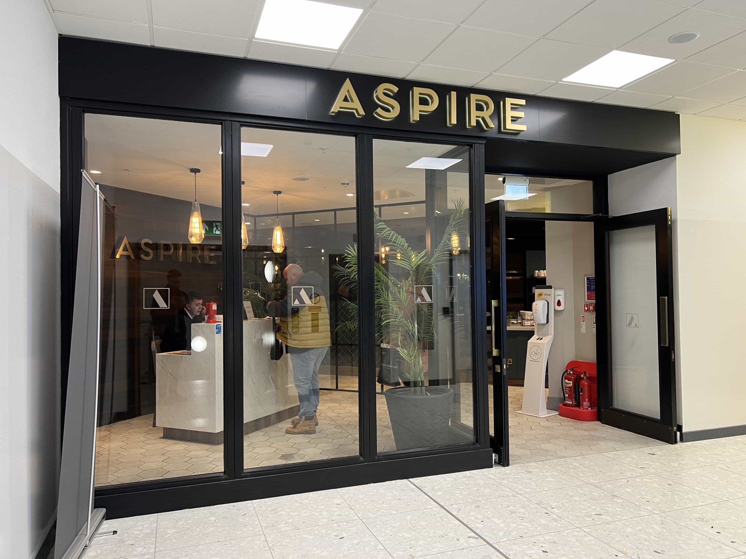 The glass-fronted entrance to Aspire Lounge at gate 16