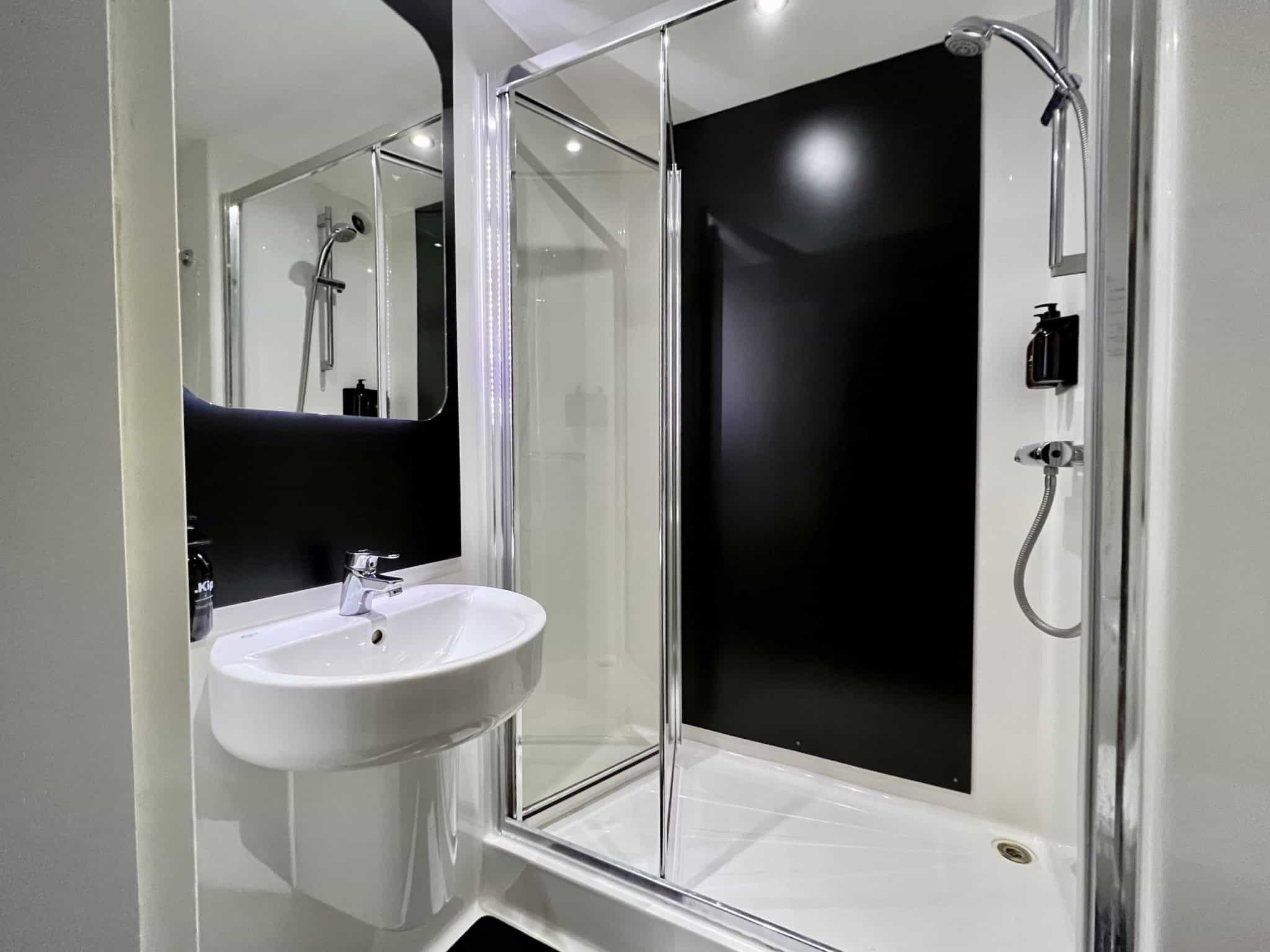 A spotlessly clean bathroom, with a sink and shower visible