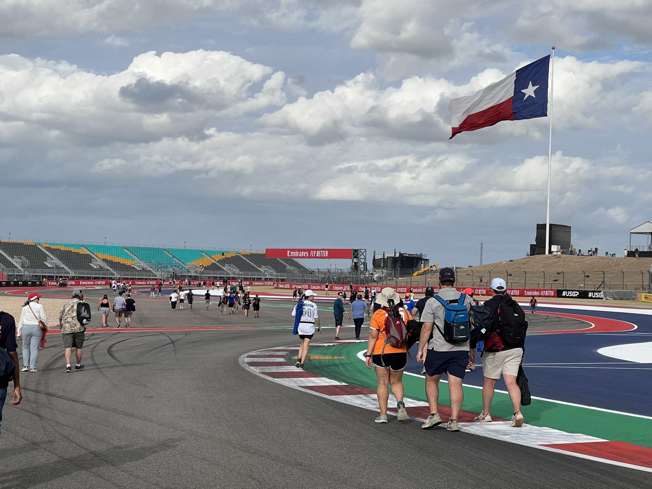A view of Turns 6, 7, and 8 at COTA, with fans exploring the track after a race