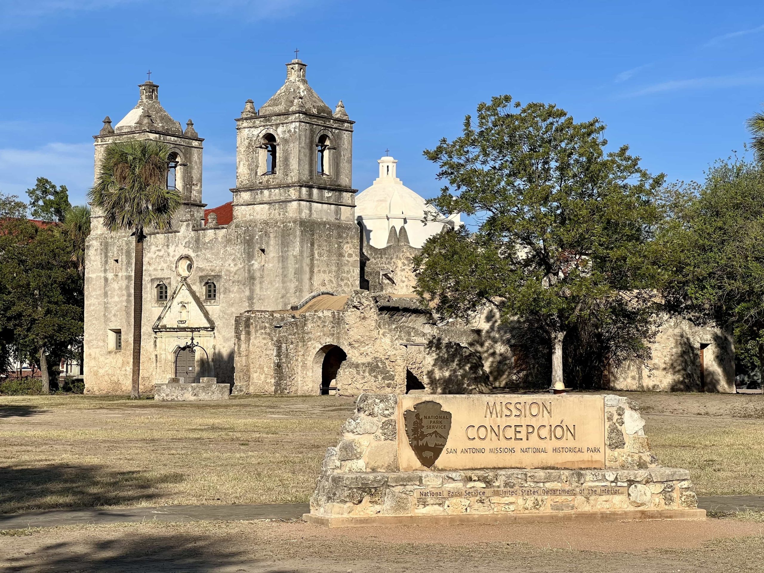The church of Mission Concepción in San Antonio, with the National Parks sign out front