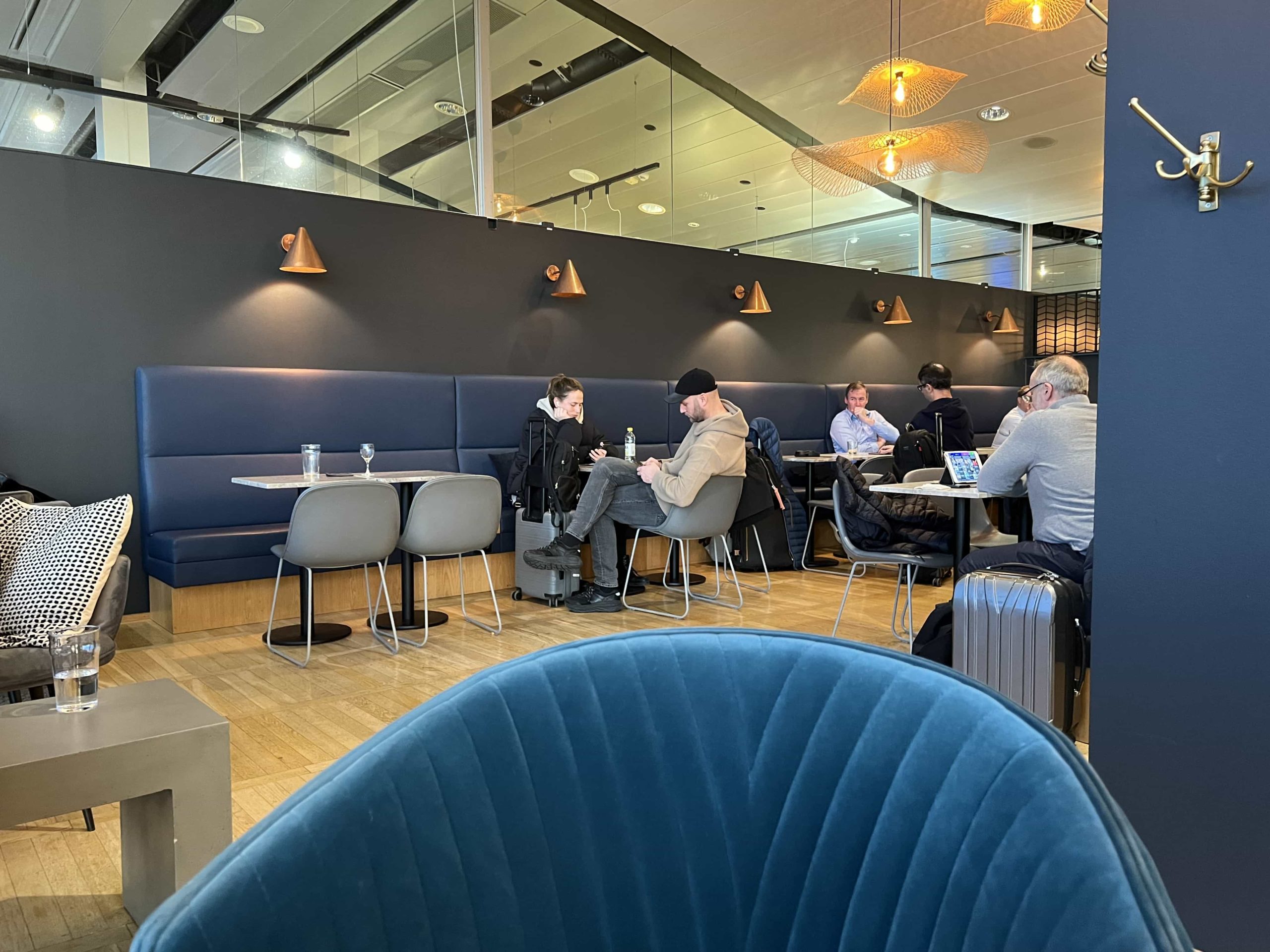 A small area of restaurant seating in the corner of an airport lounge