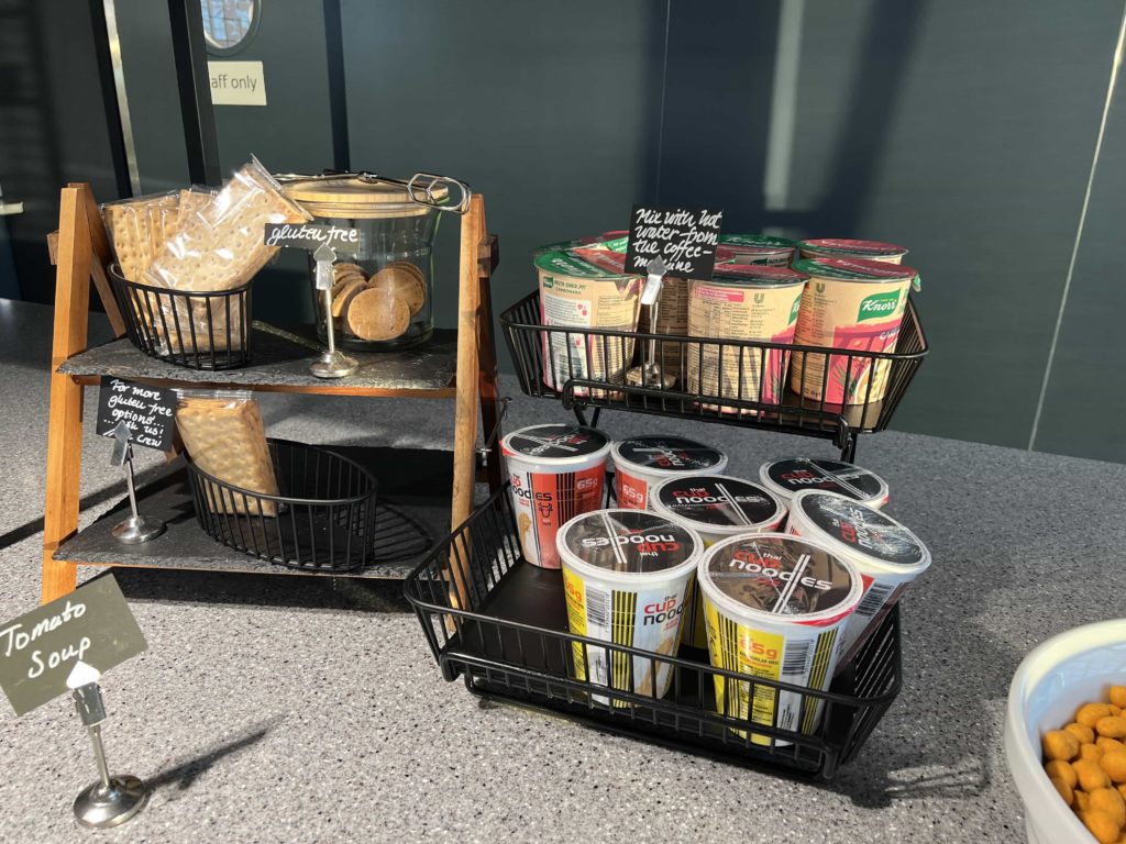 A selection of crackers, next to baskets of Thai cup noodle pots