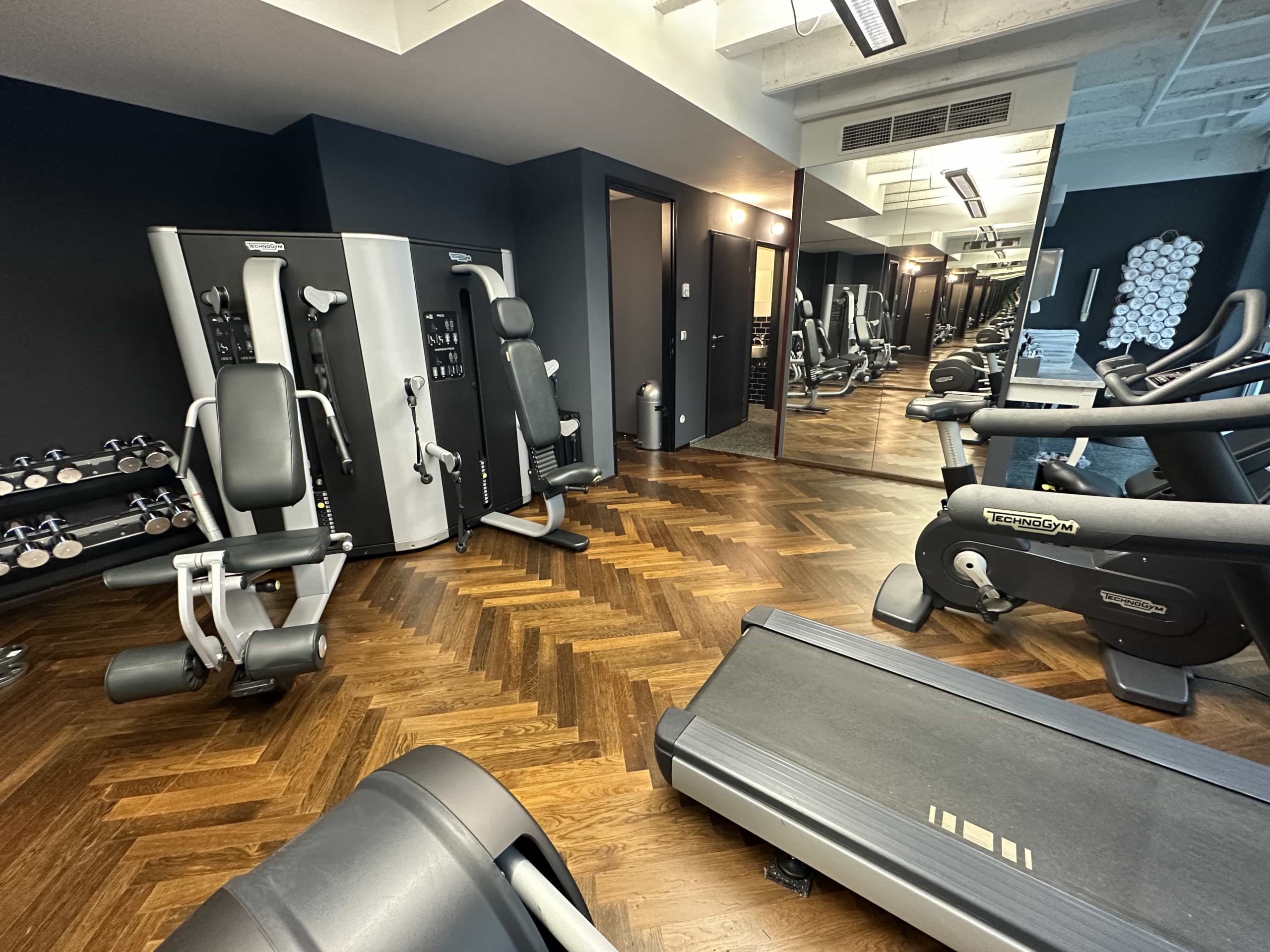Gym equipment in a room which also features toilet and shower facilities