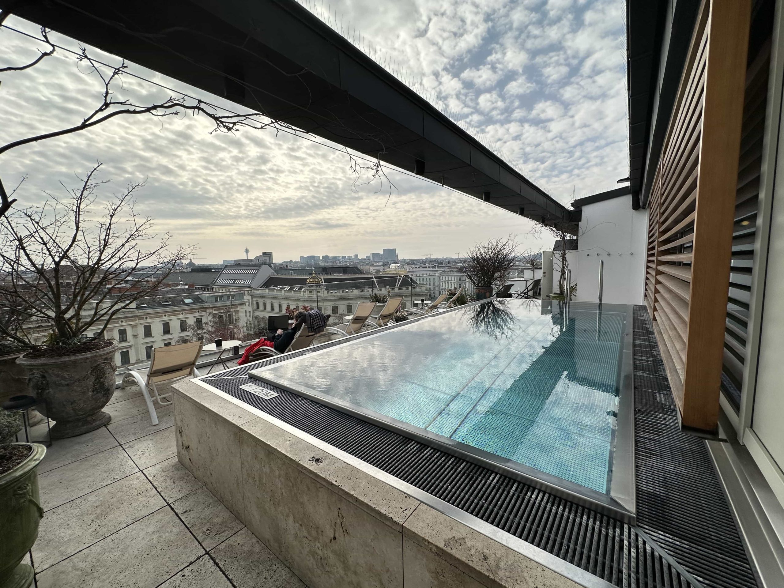 A rooftop terrace, with a small pool, overlooking views of the city of Vienna