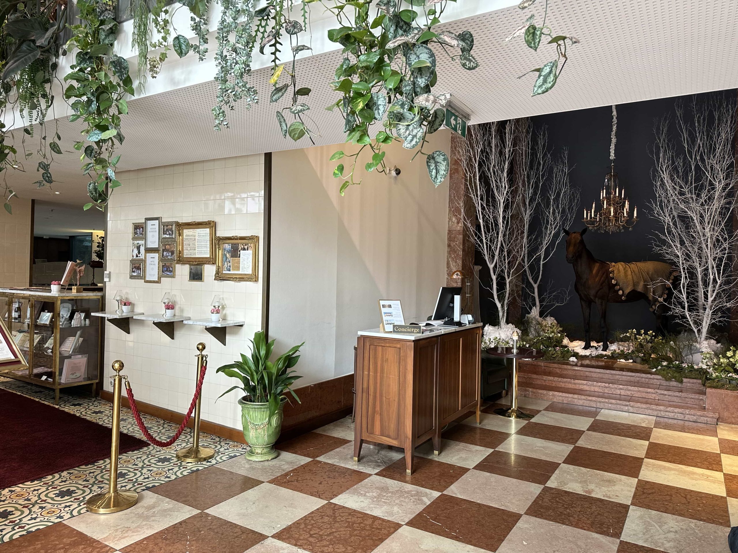 A concierge desk in the entrance to a hotel lobby