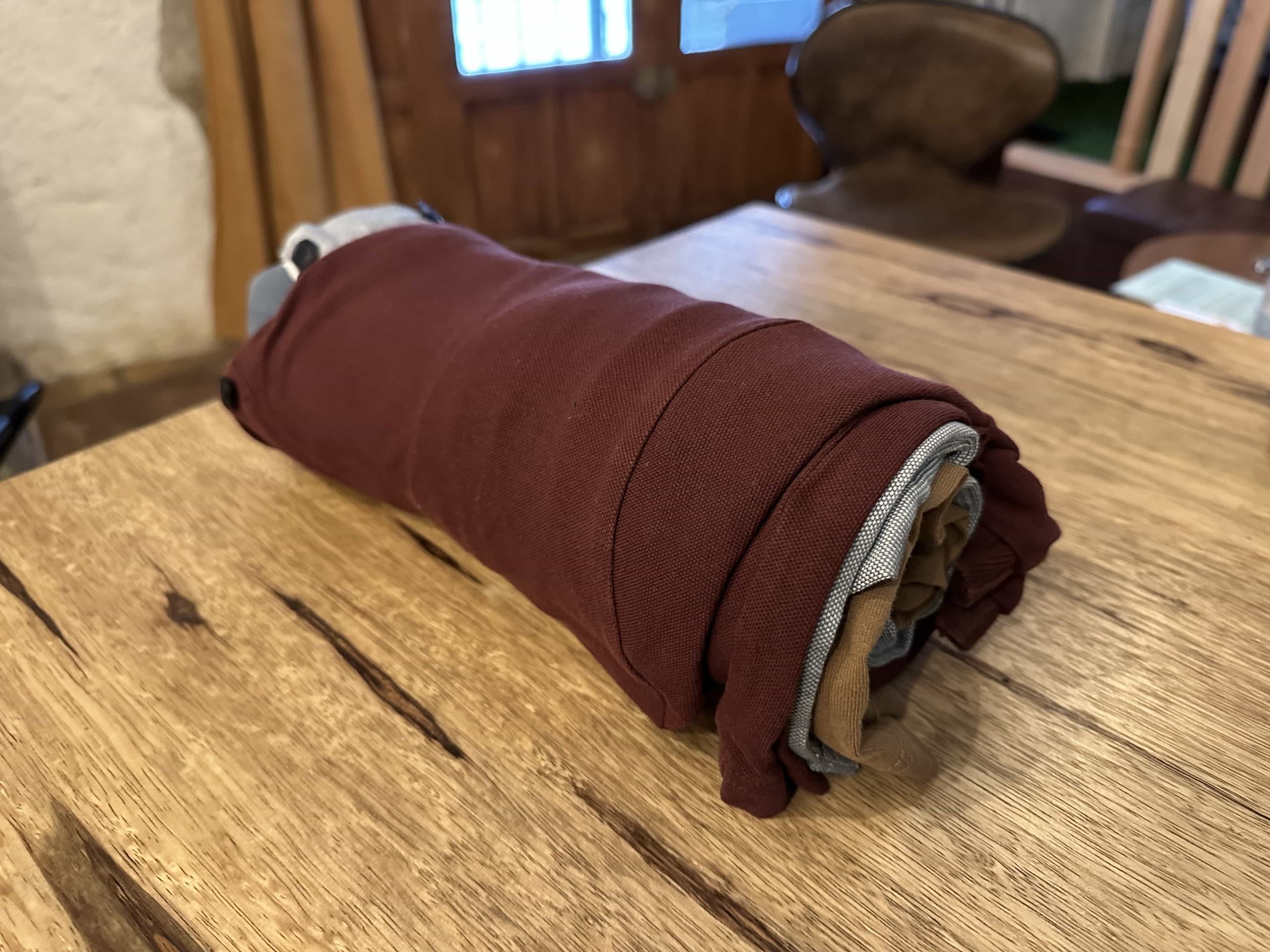 Multiple items of clothing rolled together into a tube