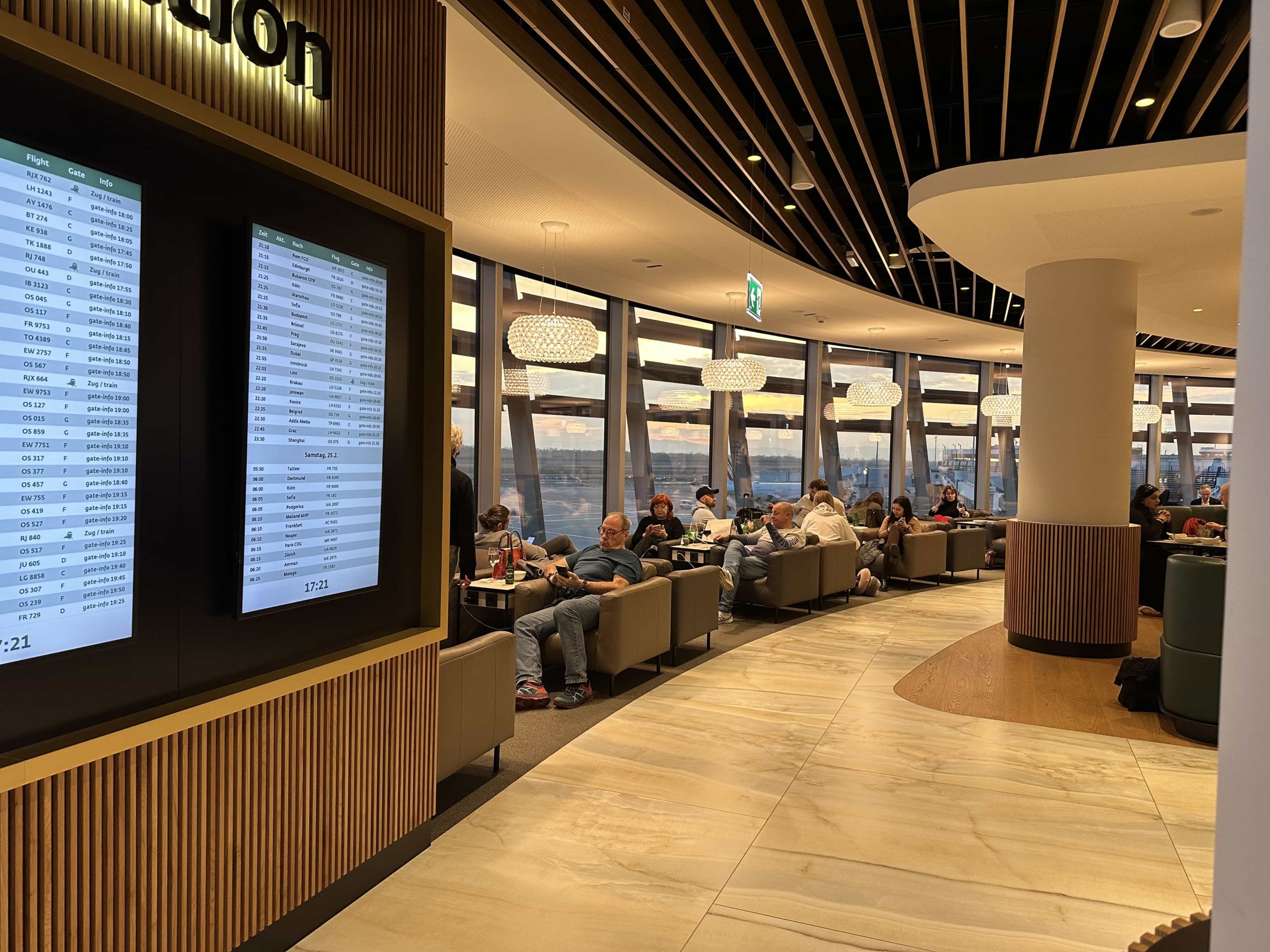 Sweeping, panoramic windows, encircling the main space in an airport lounge