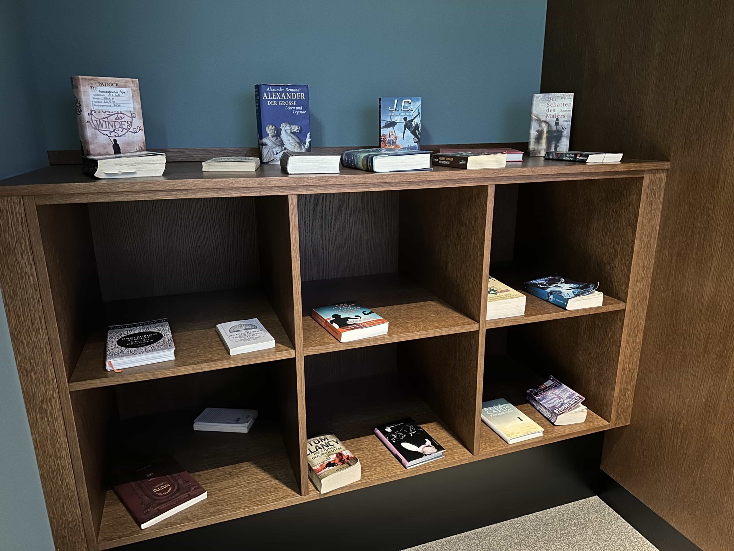 Bookshelves with an assortment of books for visitors of an airport lounge