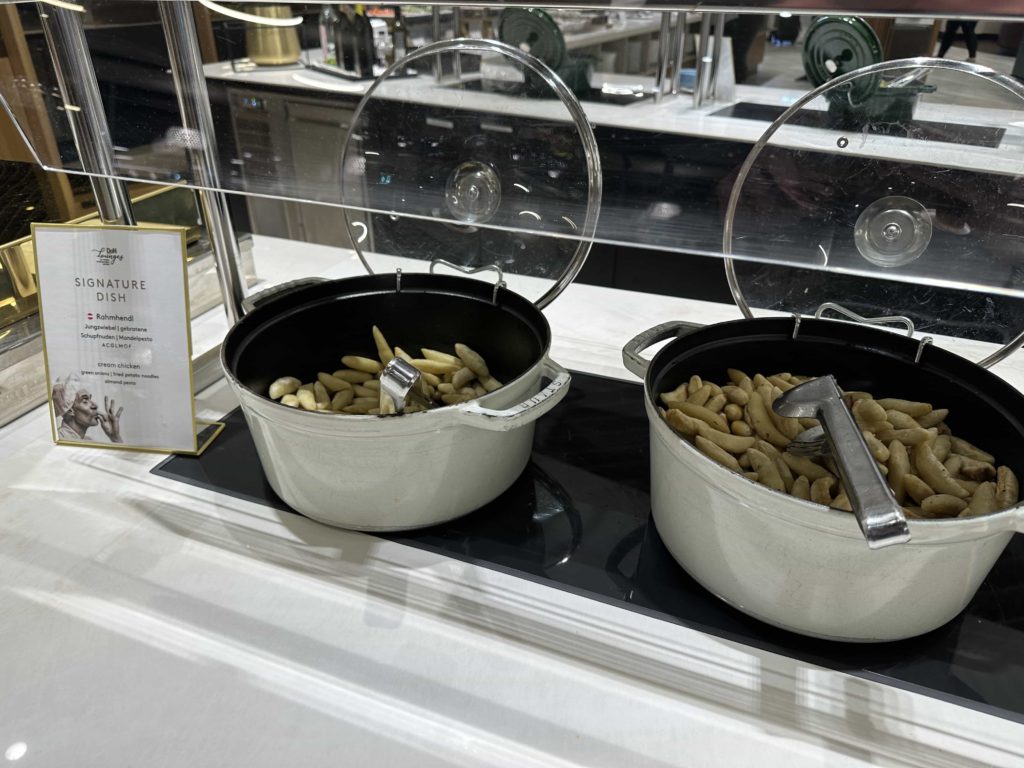 Pots of food (fried potato noodles) at a buffet station