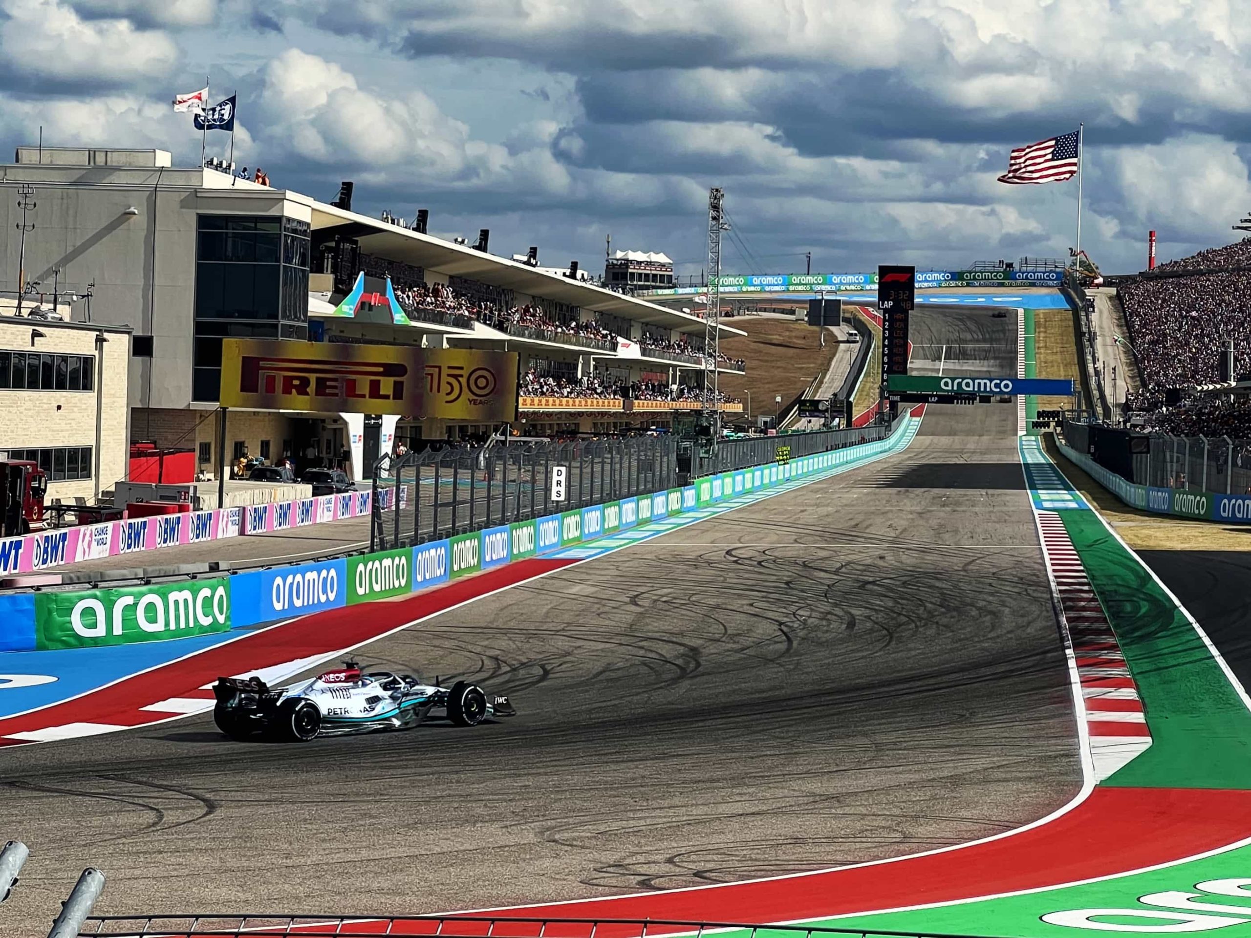 A view up the main straight at COTA, with Lewis Hamilton's F1 car exiting the final corner