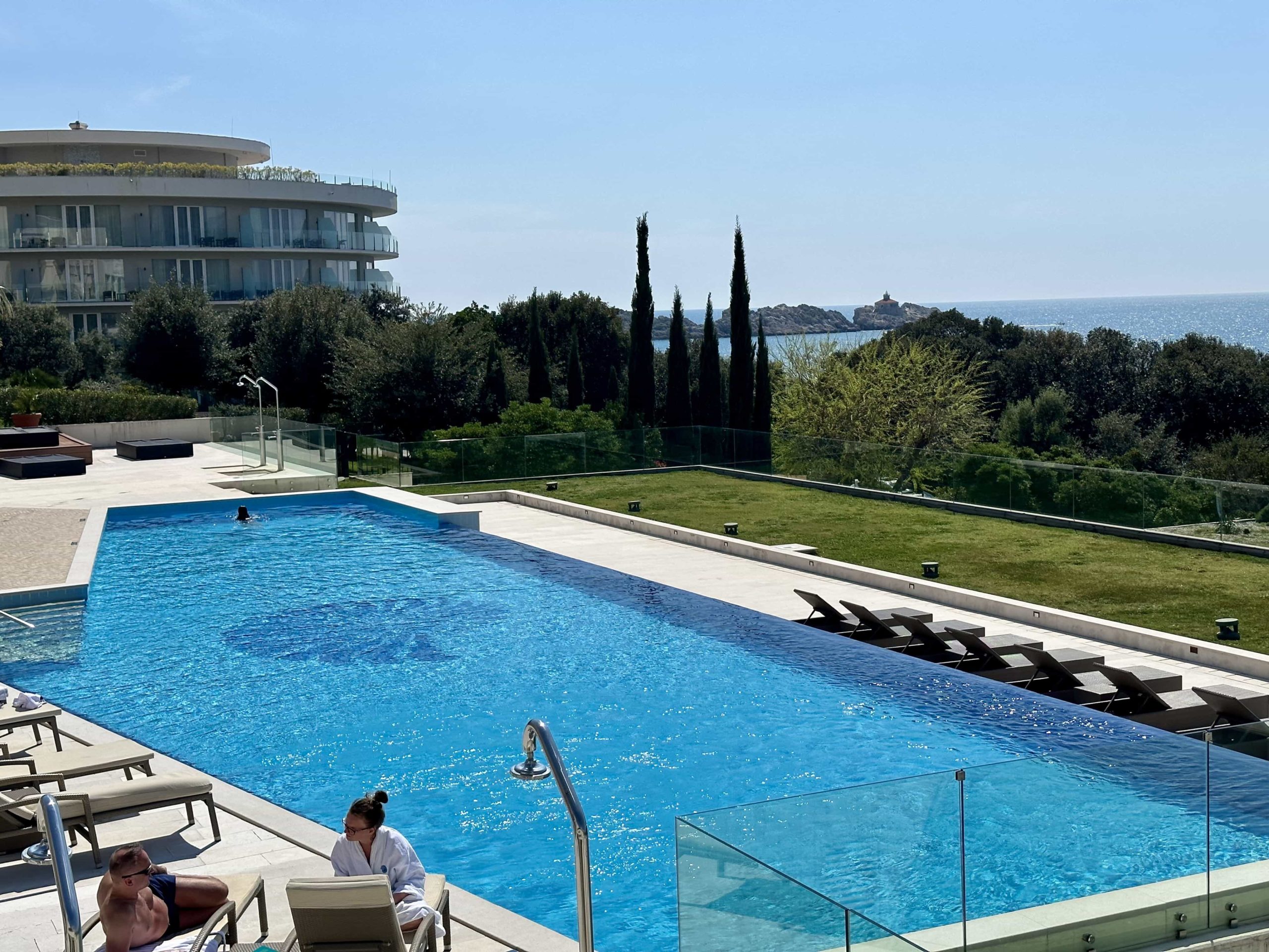 A view down over an outdoor infinity pool, with views over the sea