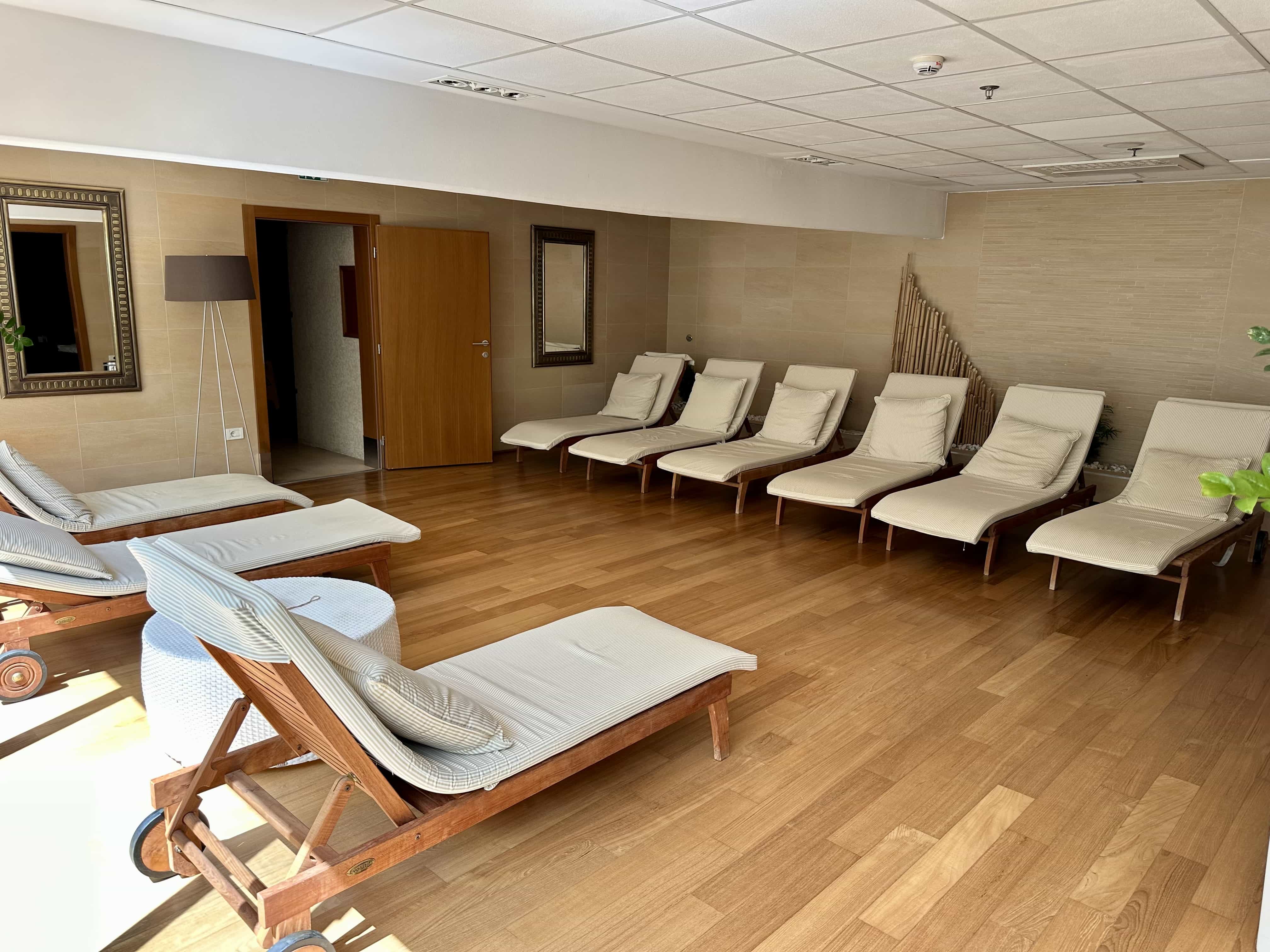 An indoor relaxation area with deck chairs and amenities