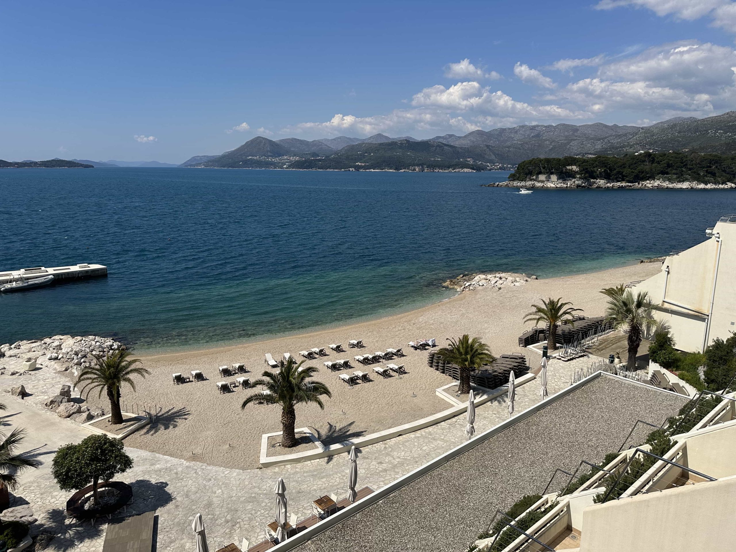 A balcony view overlooking a private hotel beach and the Adriatic Sea