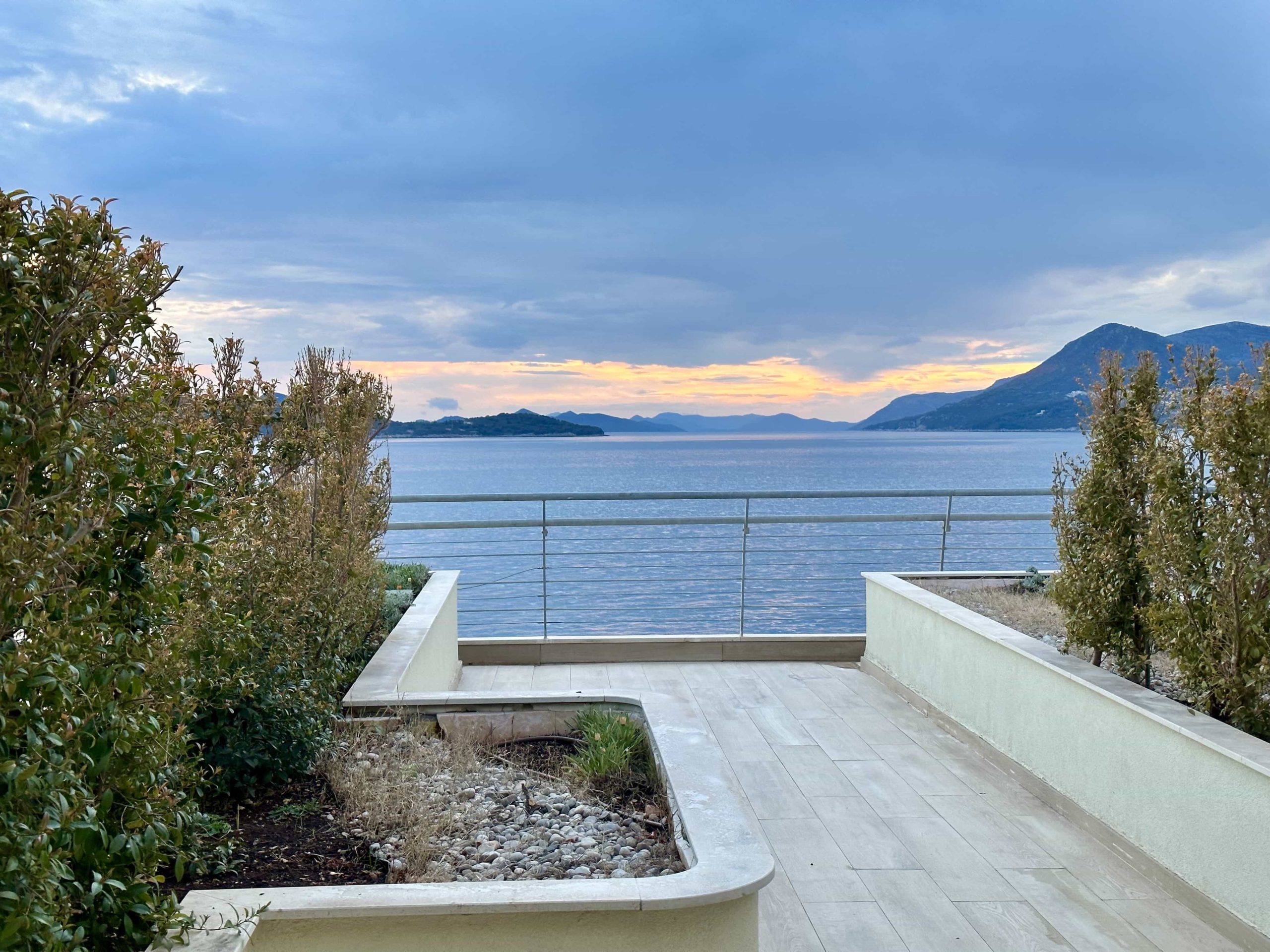 A view from a hotel room terrace of a sunset over the Adriatic Sea