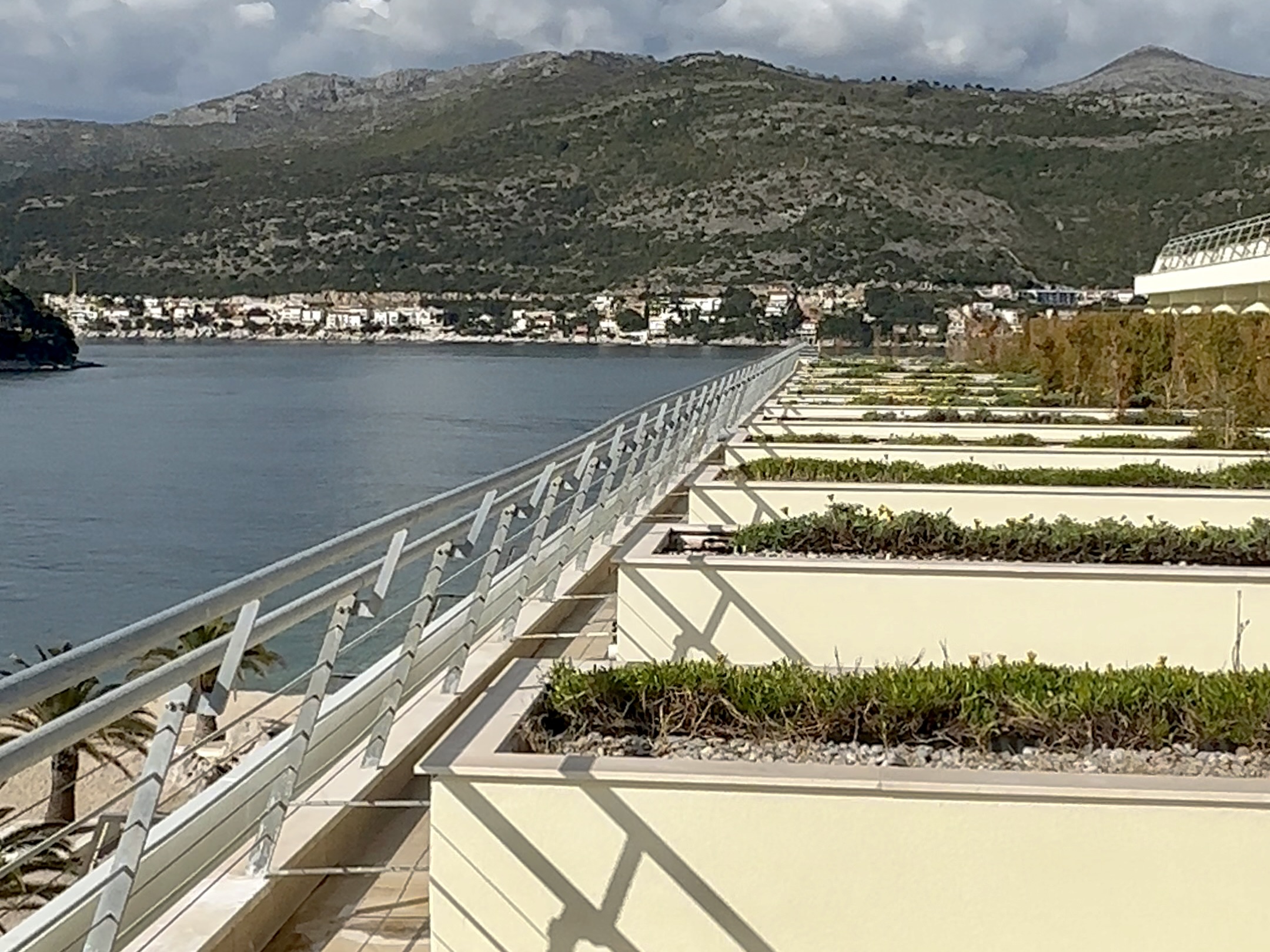 A view across the front of the terraces of a series of hotel rooms