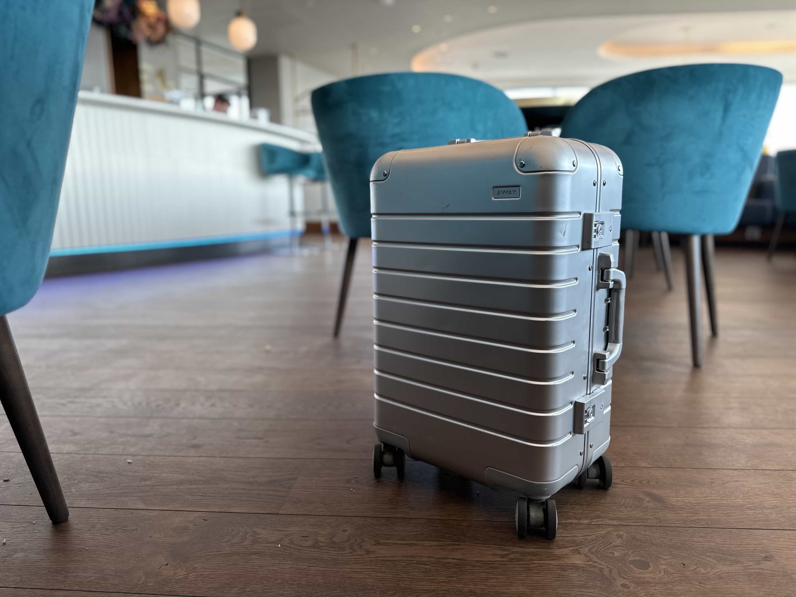 A suitcase in the middle of a dining area in an airport lounge