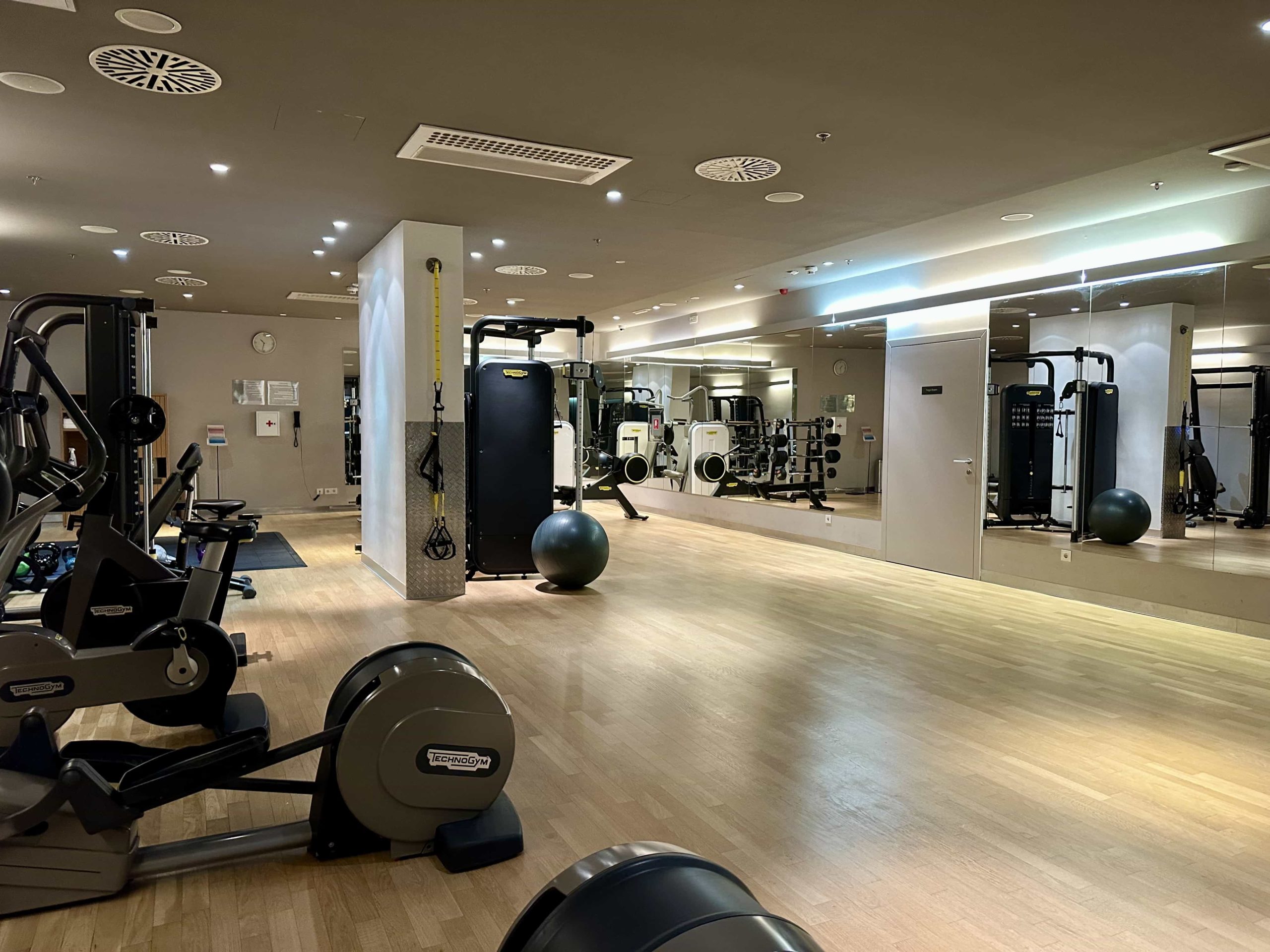 A gym with cardio machines on the left, and an open floor area on the right