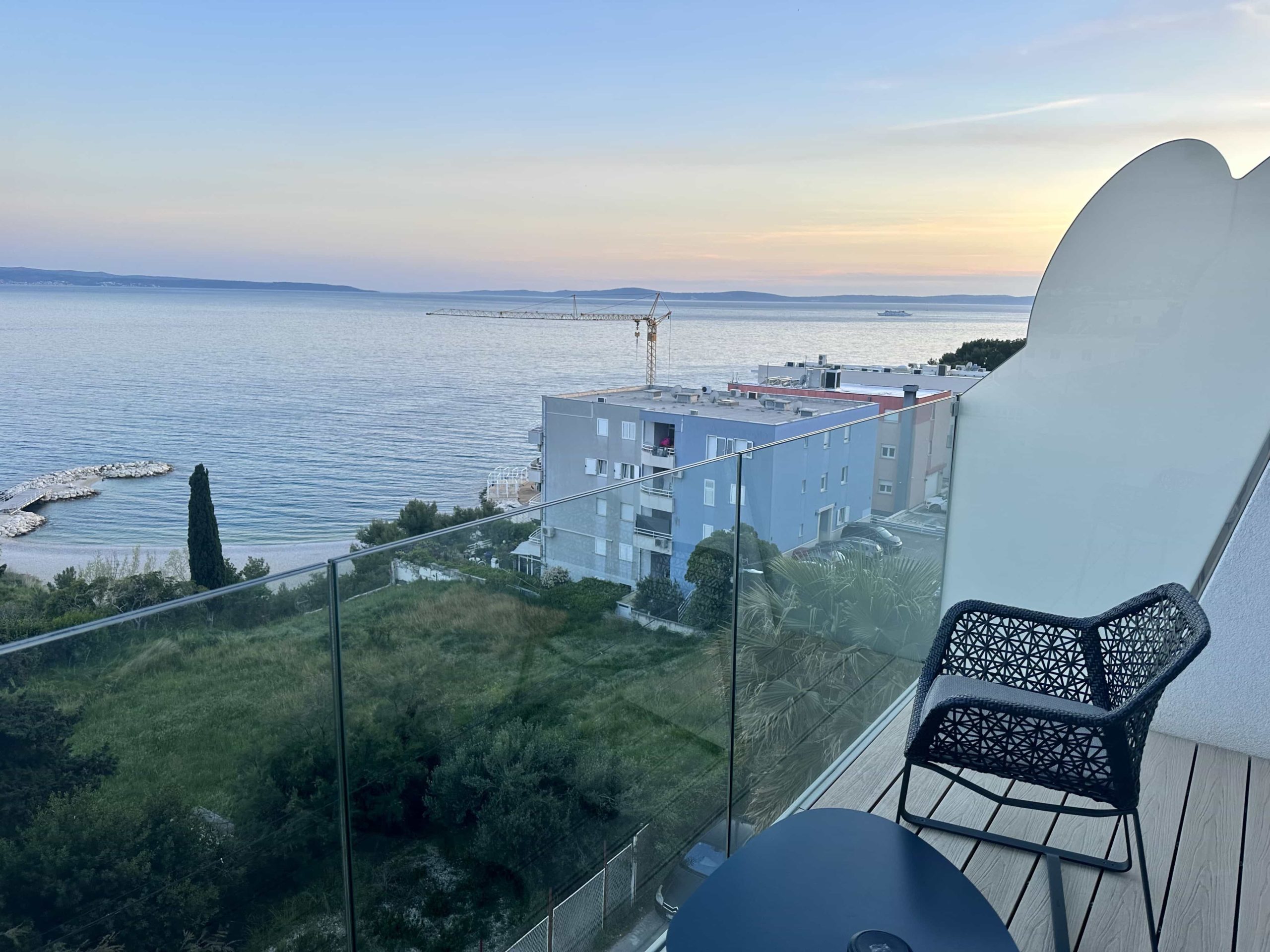 A view from a hotel room balcony, overlooking the sea