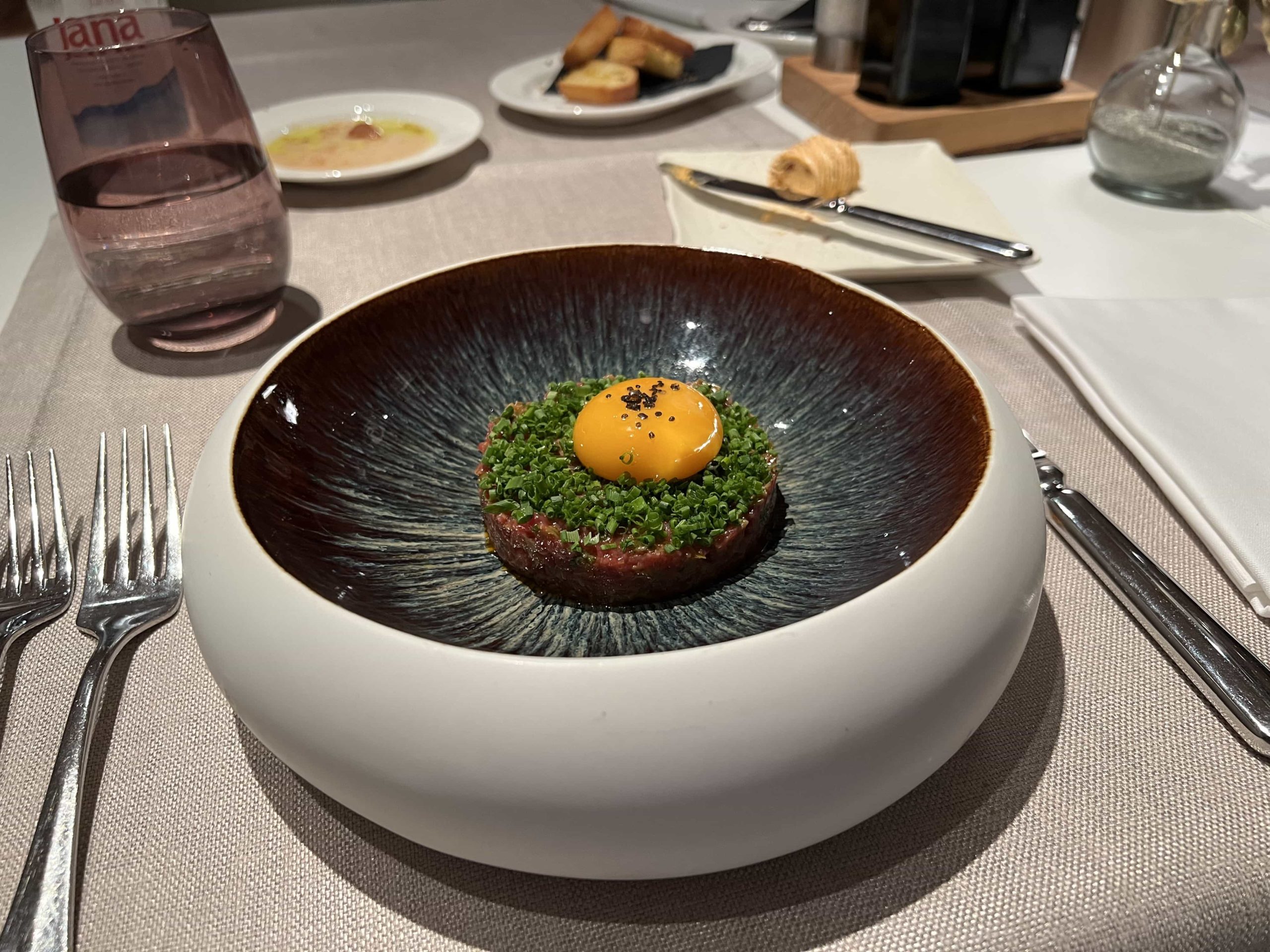 A steak tartare dish within a lavish concave bowl