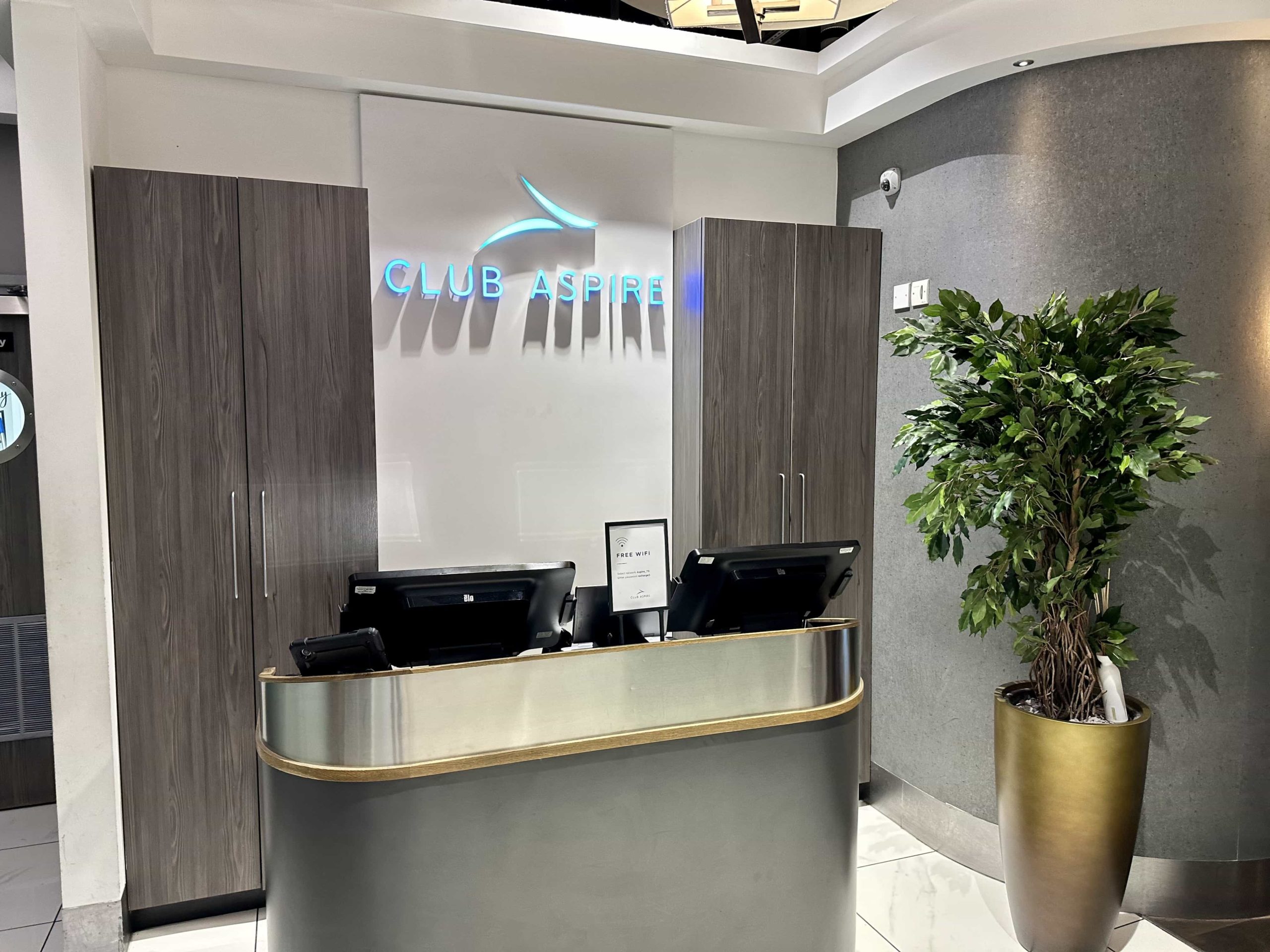 A reception desk with "Club Aspire" signage on the wall behind