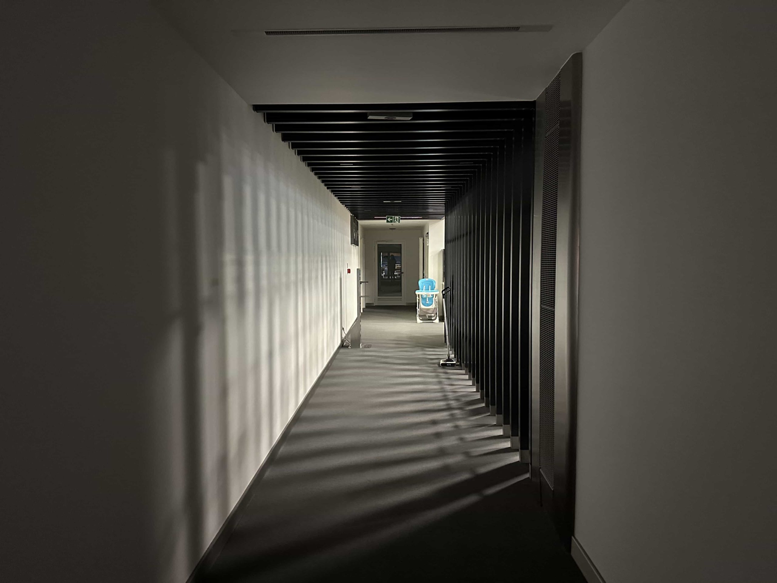 A dark, ominous corridor leading to a doorway