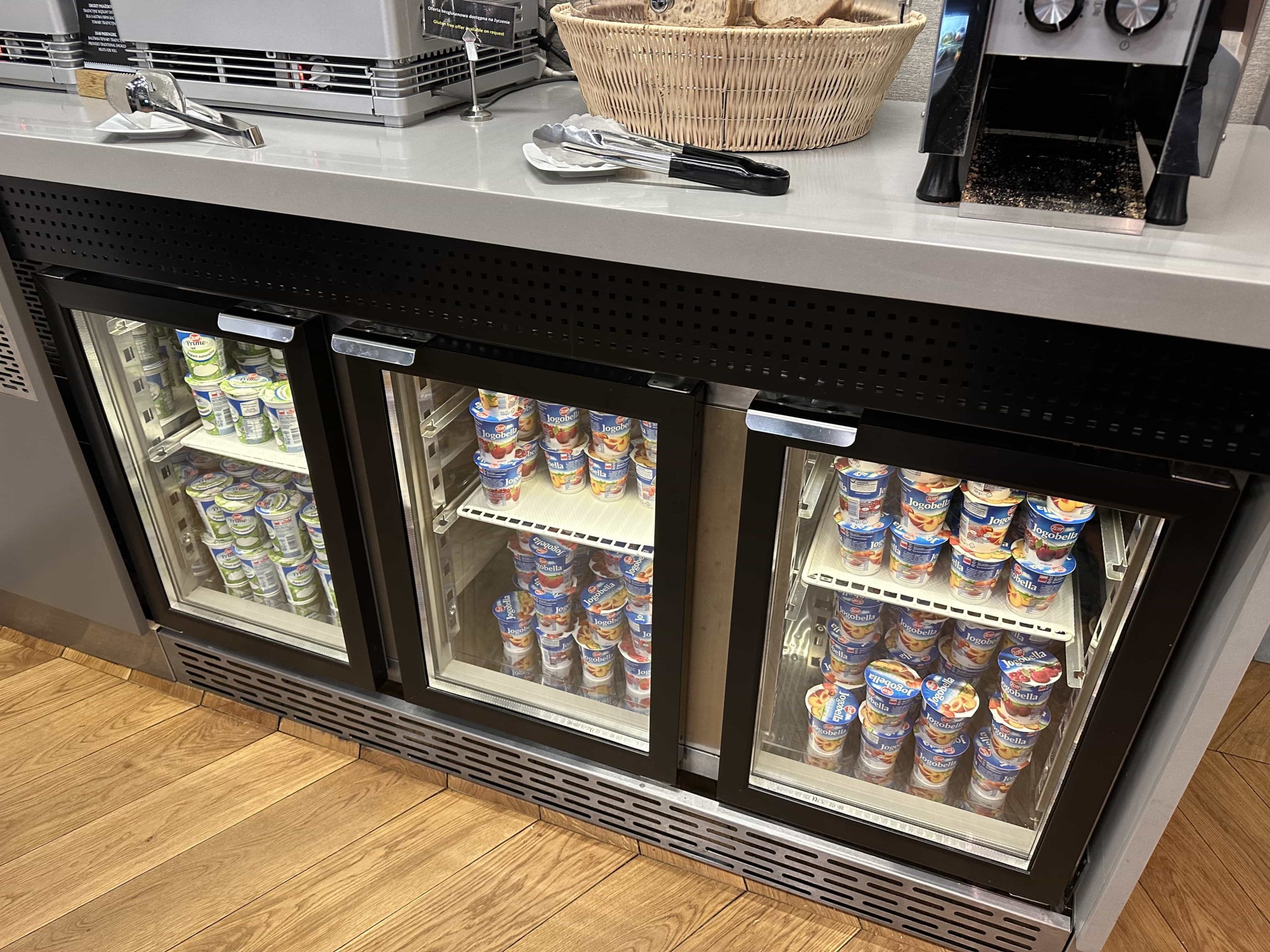 Three fridges with a variety of yogurts