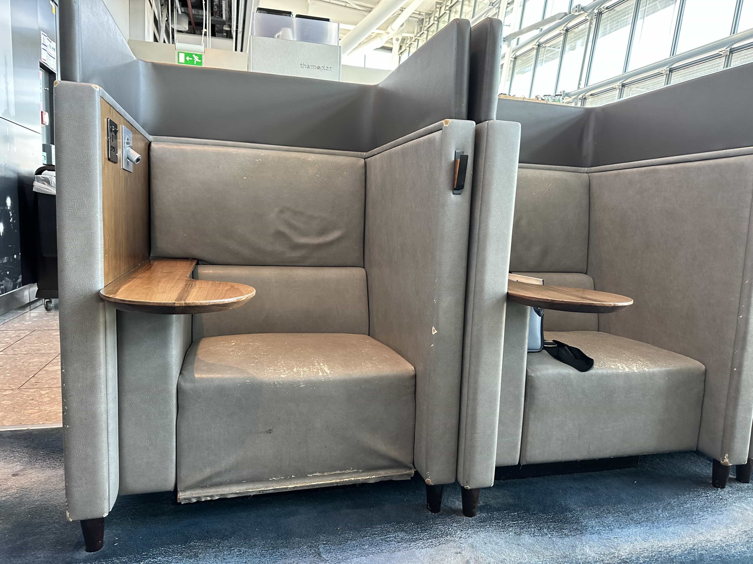 Two booth seats, side-by-side in an airport lounge