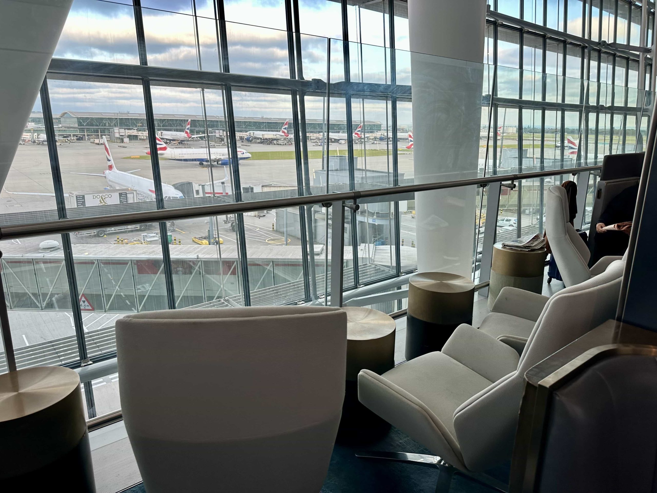 An arrangement of high-backed armchairs overlooking the apron at an airport