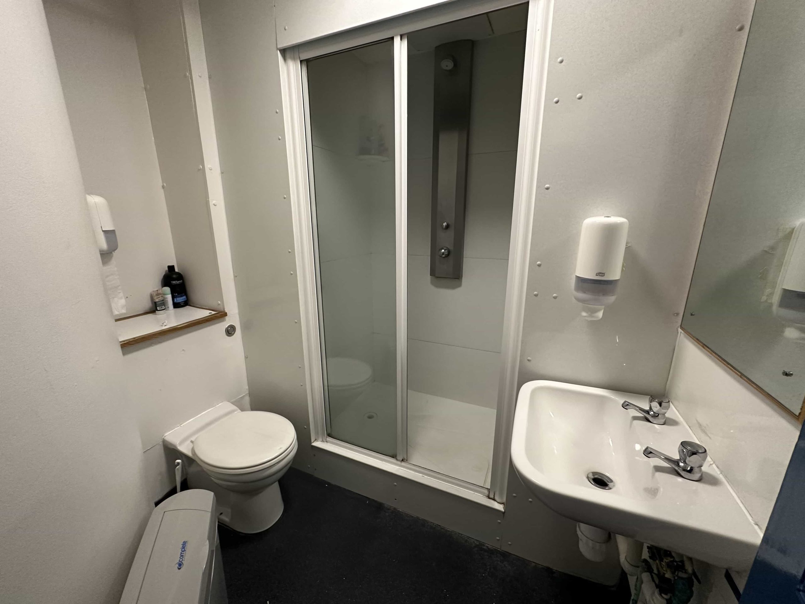 A small bathroom with a shower cubicle