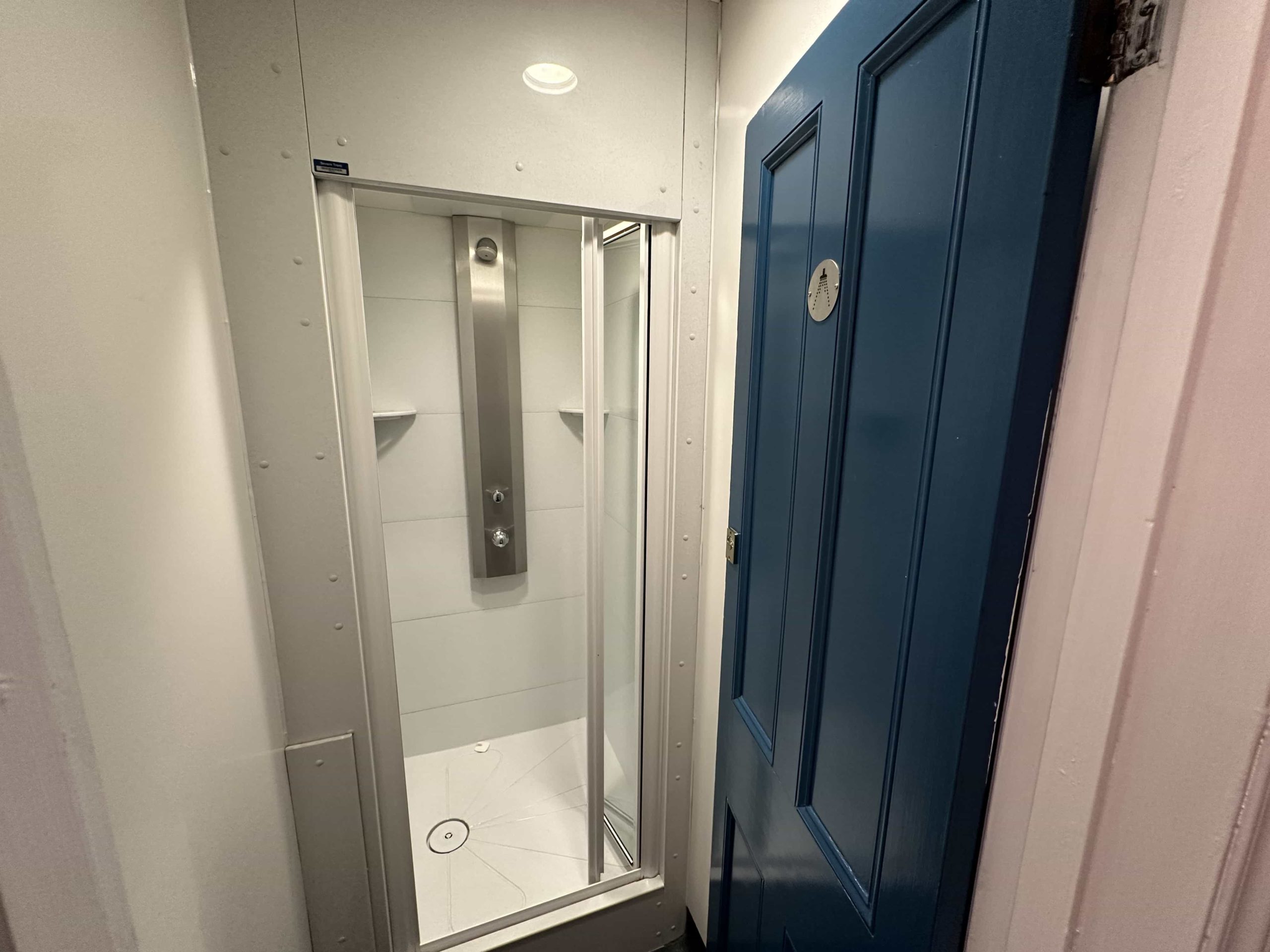 A dedicated shower room with a shower cubicle, and a small area to change