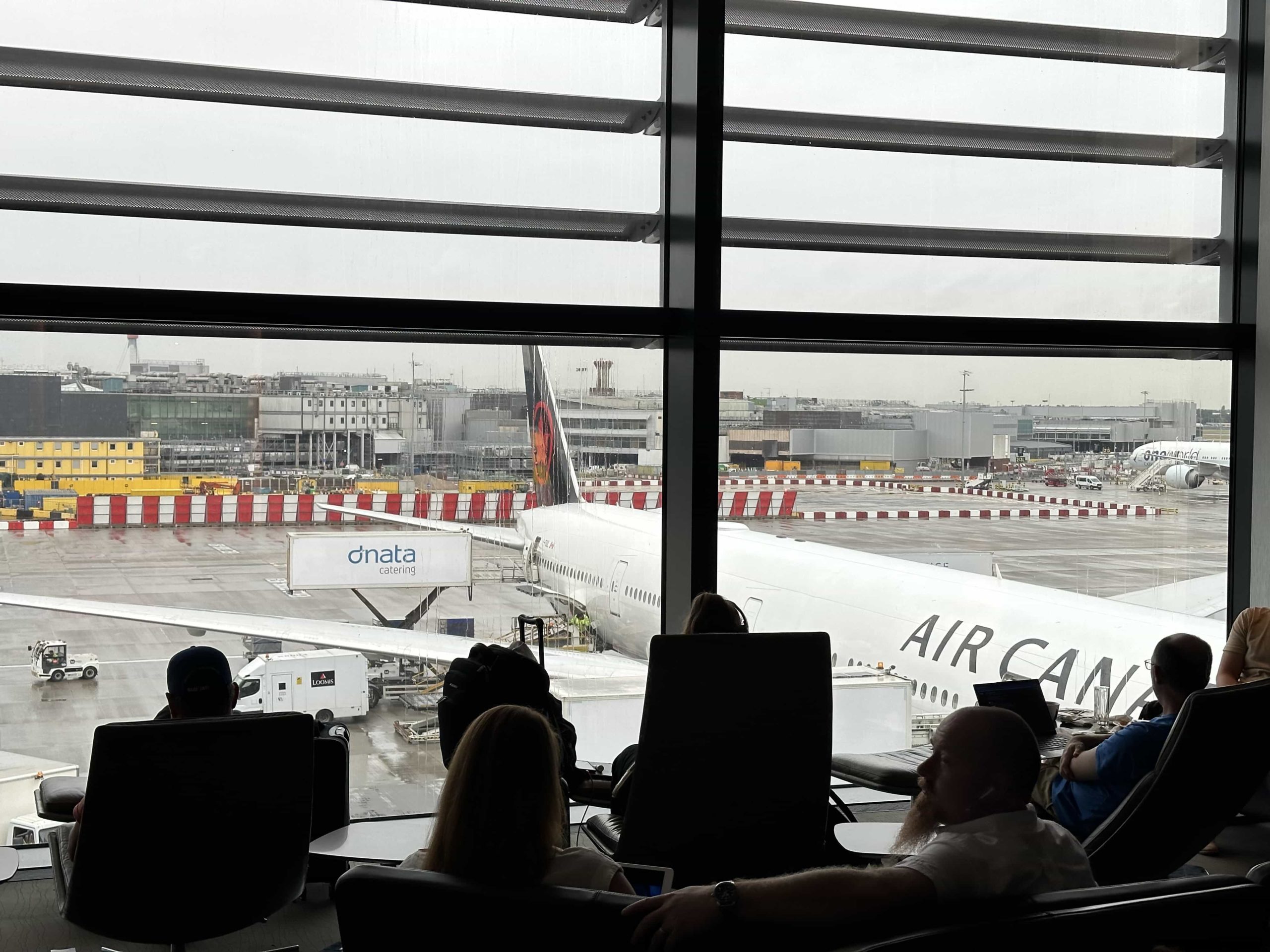 People sitting in reclinable floor-to-ceiling windows, overlooking the apron