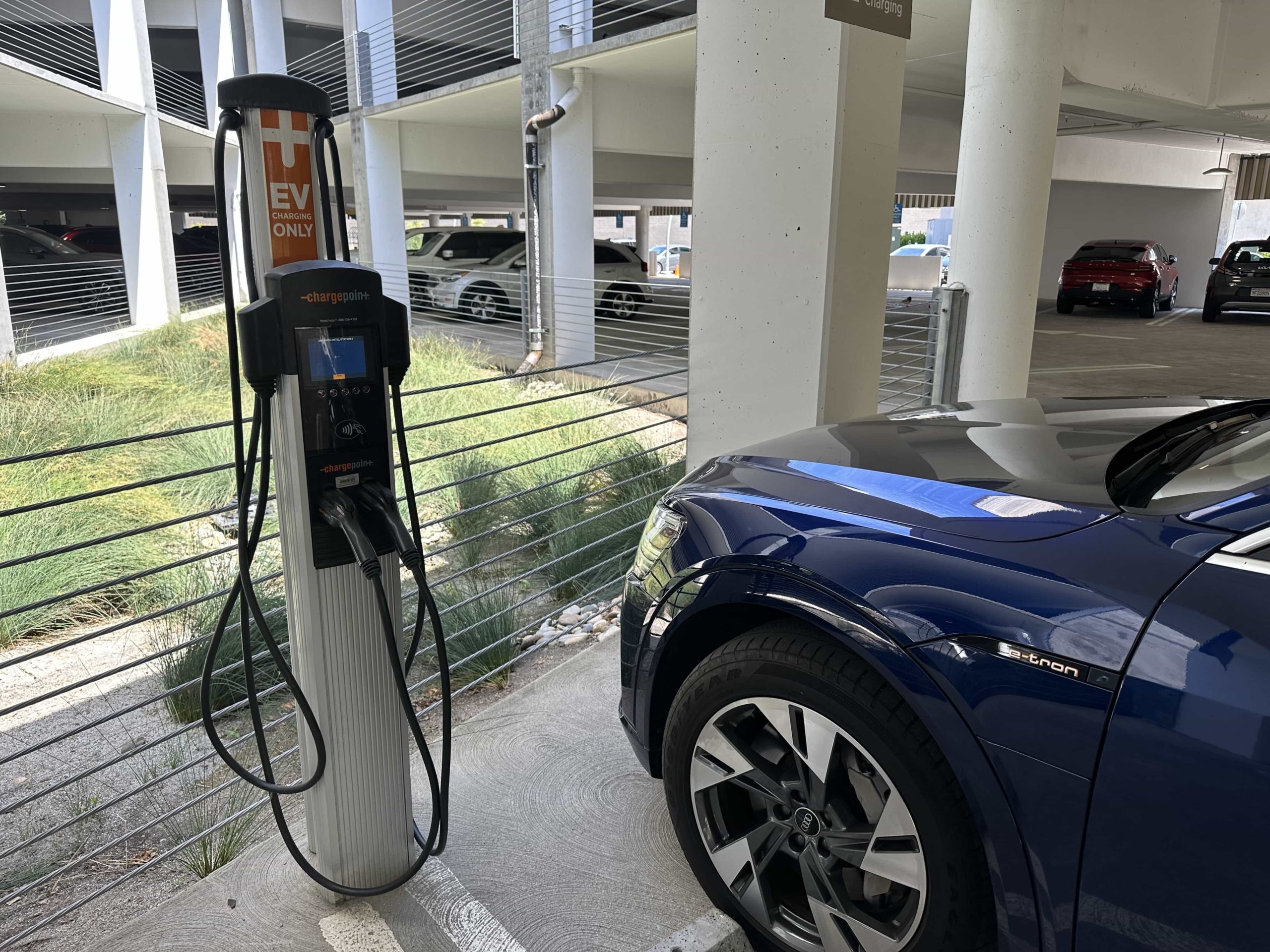 An electric Audi parked in an EV charging spot