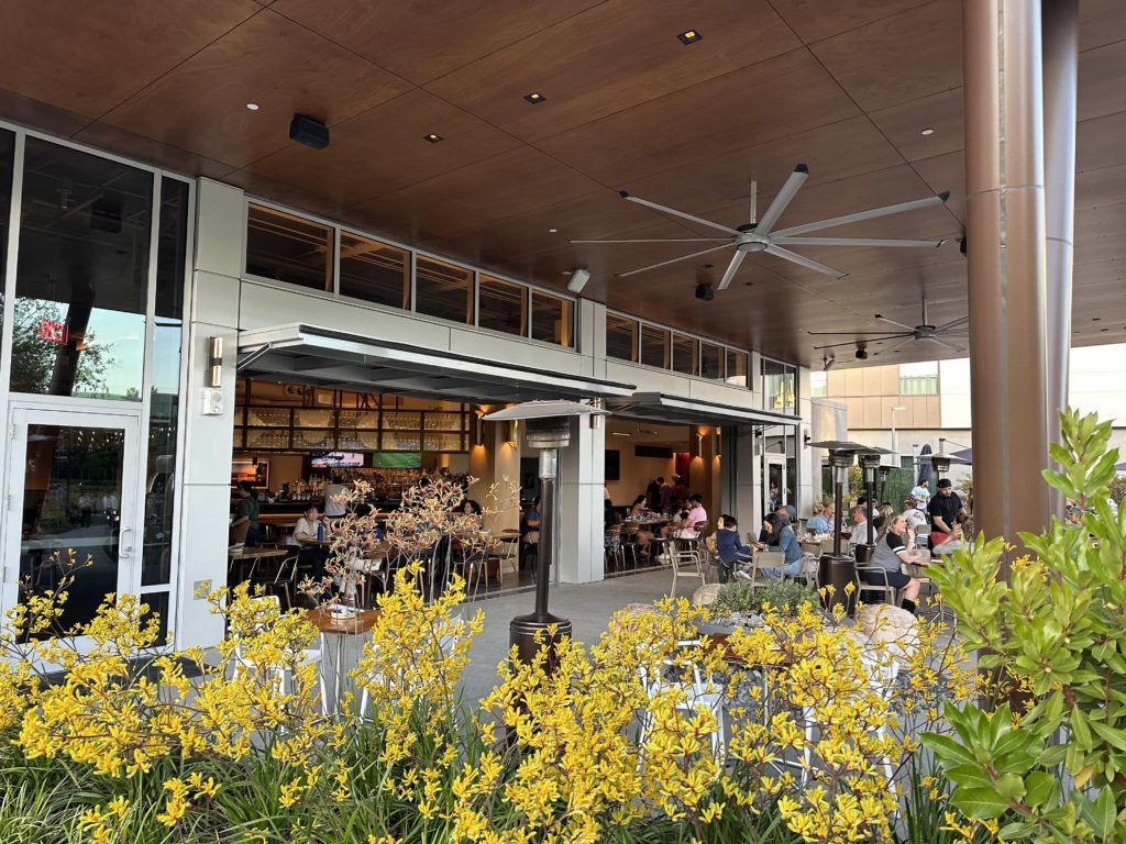 An outdoor seating area in front of The Ameswell Hotel's Roger restaurant