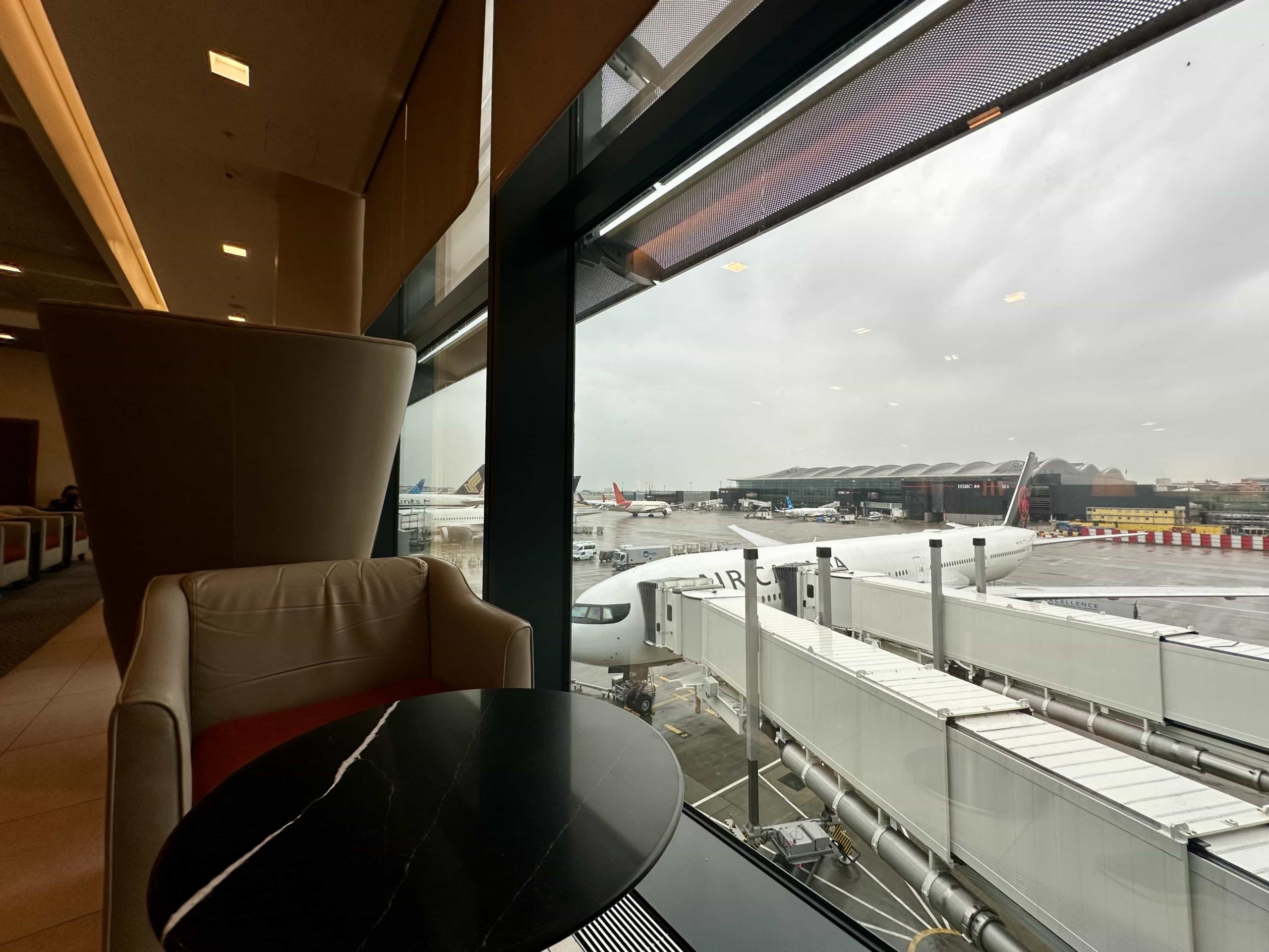 A coffee table setup overlooking a jet bridge and the apron below